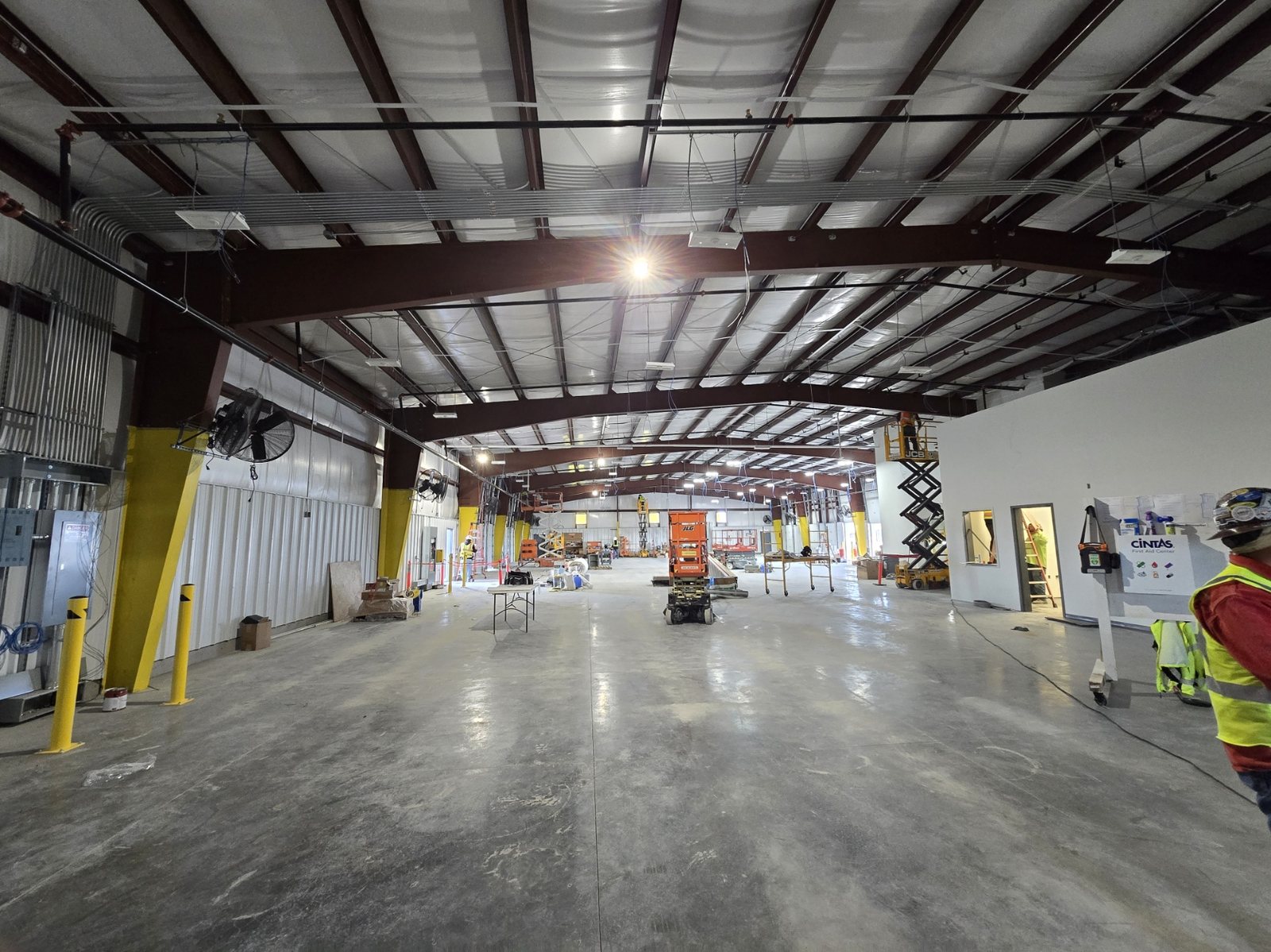 Commercial warehouse interior during low-voltage and communications infrastructure work