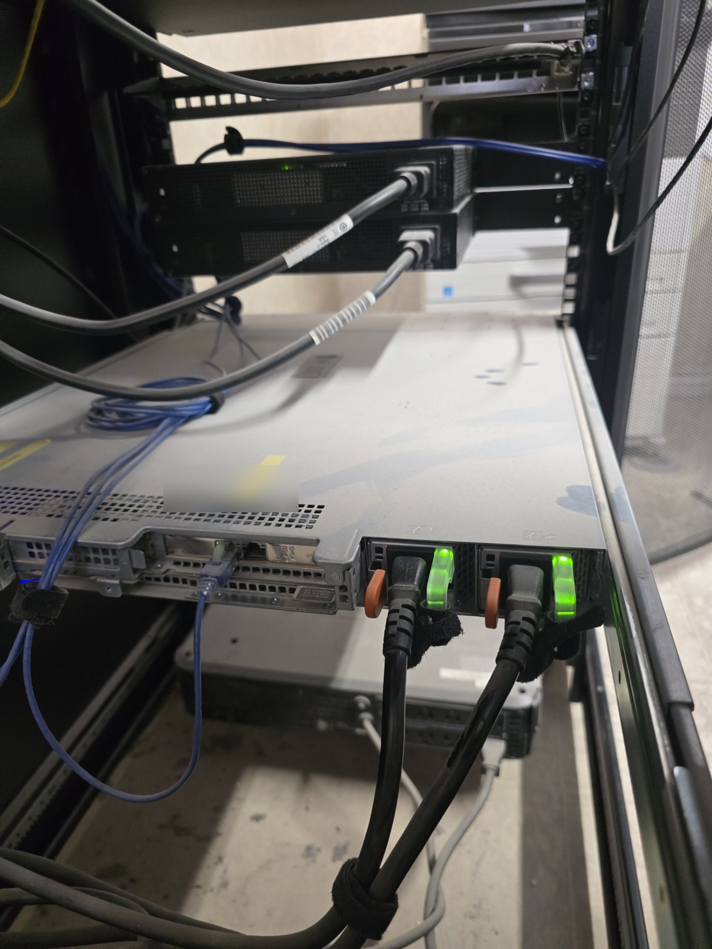 FortiGate 40F commercial firewall closeup installed in a rack with cabling