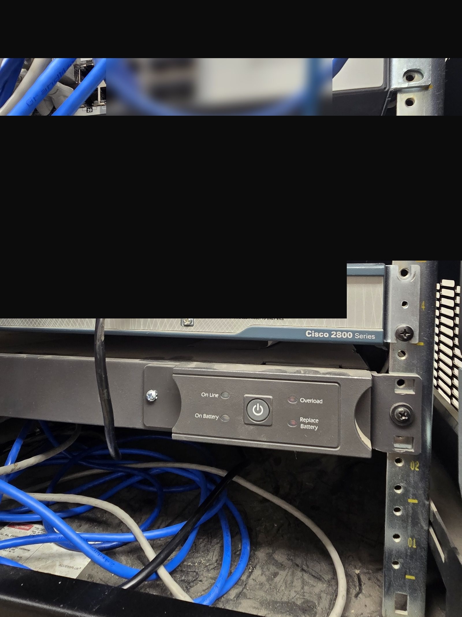 Fortinet firewall and Cisco router installed in a commercial network rack