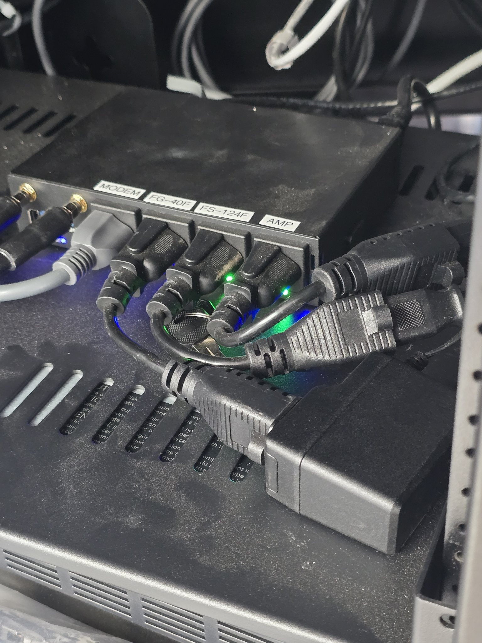 Labeled rack PDU with modem, FortiGate firewall, FortiSwitch, and amplifier circuit connections
