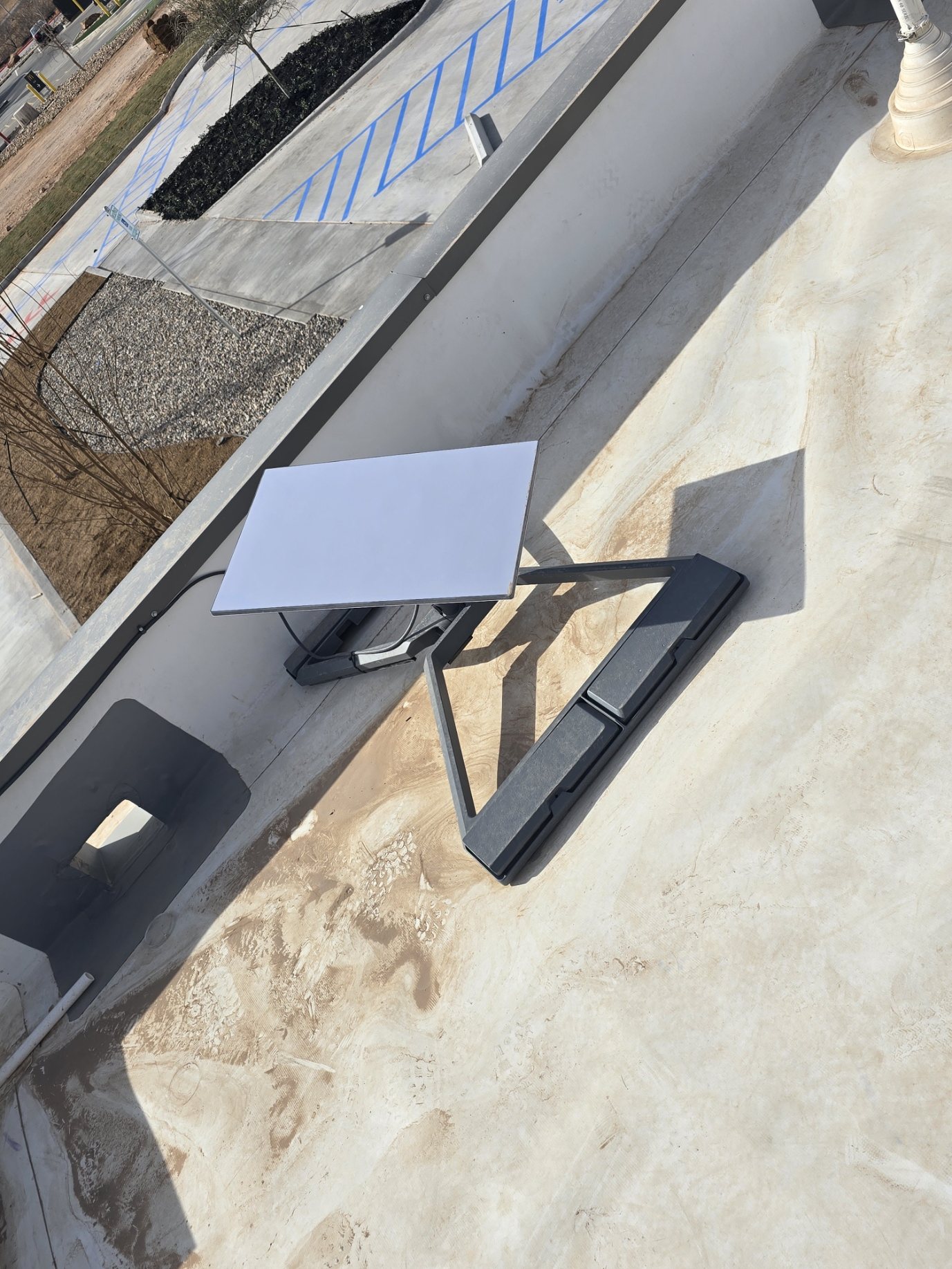 Aerial view of Starlink rooftop mount and field installation for commercial wireless support